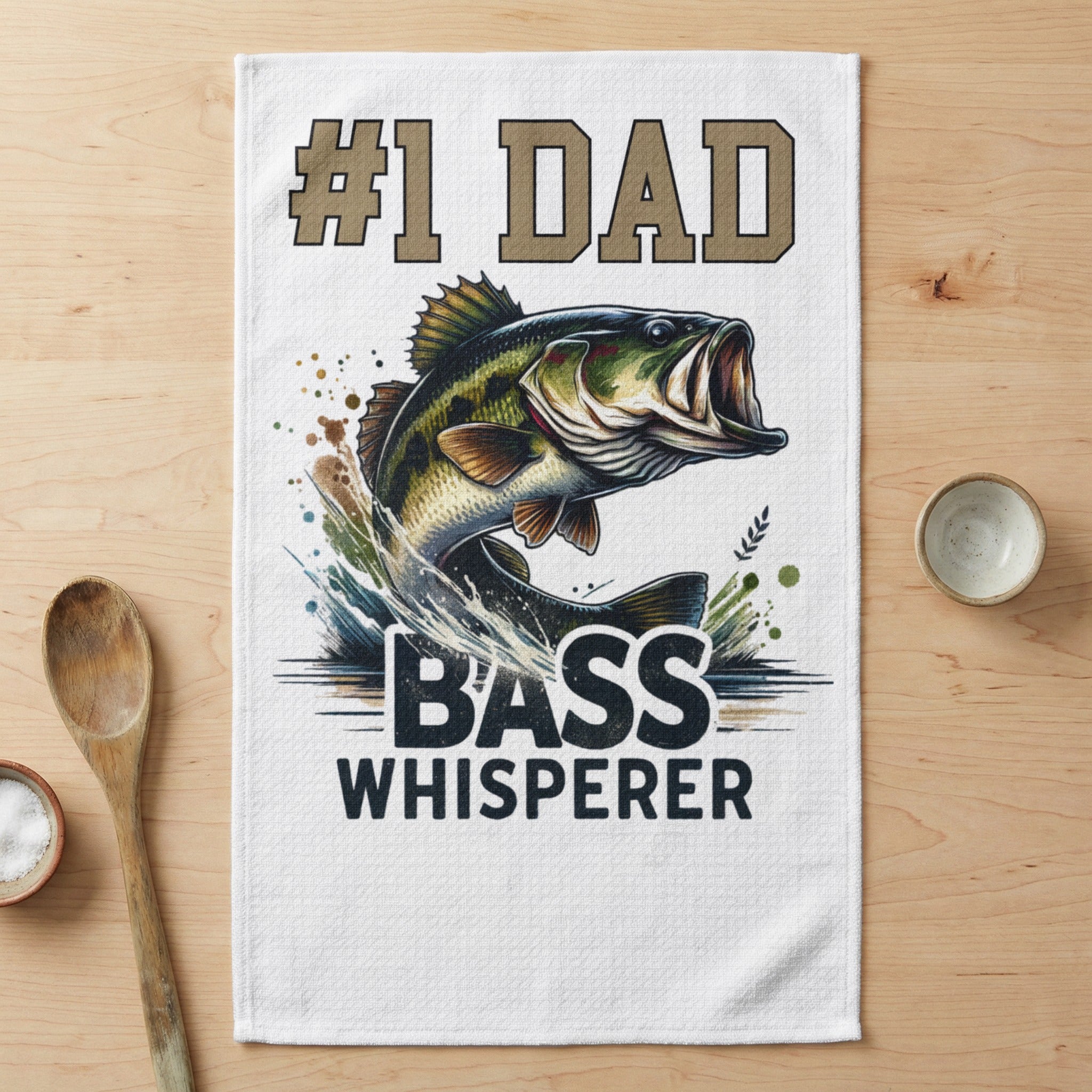 #1 Dad Bass Whisperer graphic on a white kitchen towel.