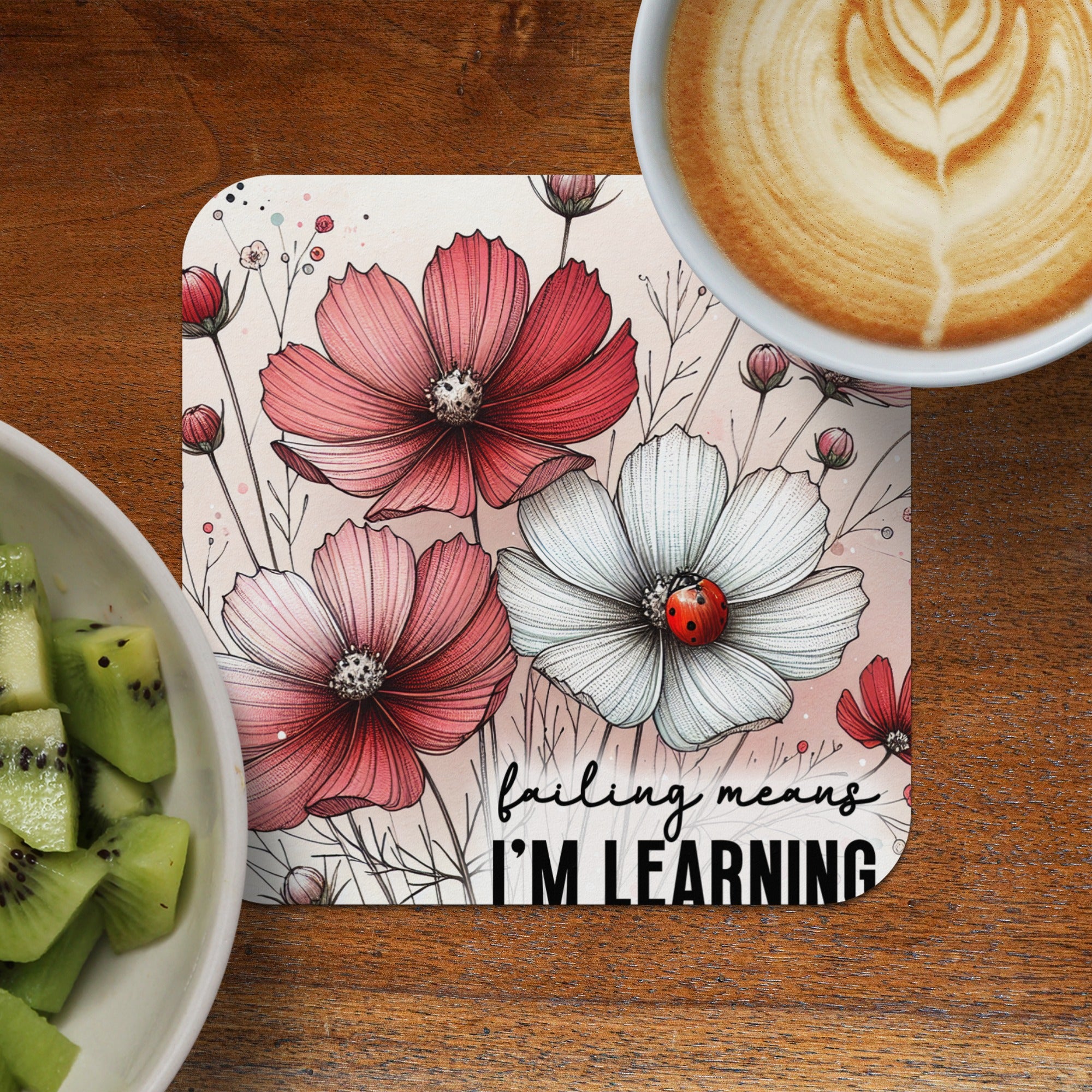 Coaster with pink and white flowers and ladybug, reads "failing means I'm learning."