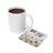 White mug of coffee next to a coaster with "BE YOU" and watercolor flowers.