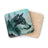 Wolf profile artwork on square coaster, overlaid on another coaster.