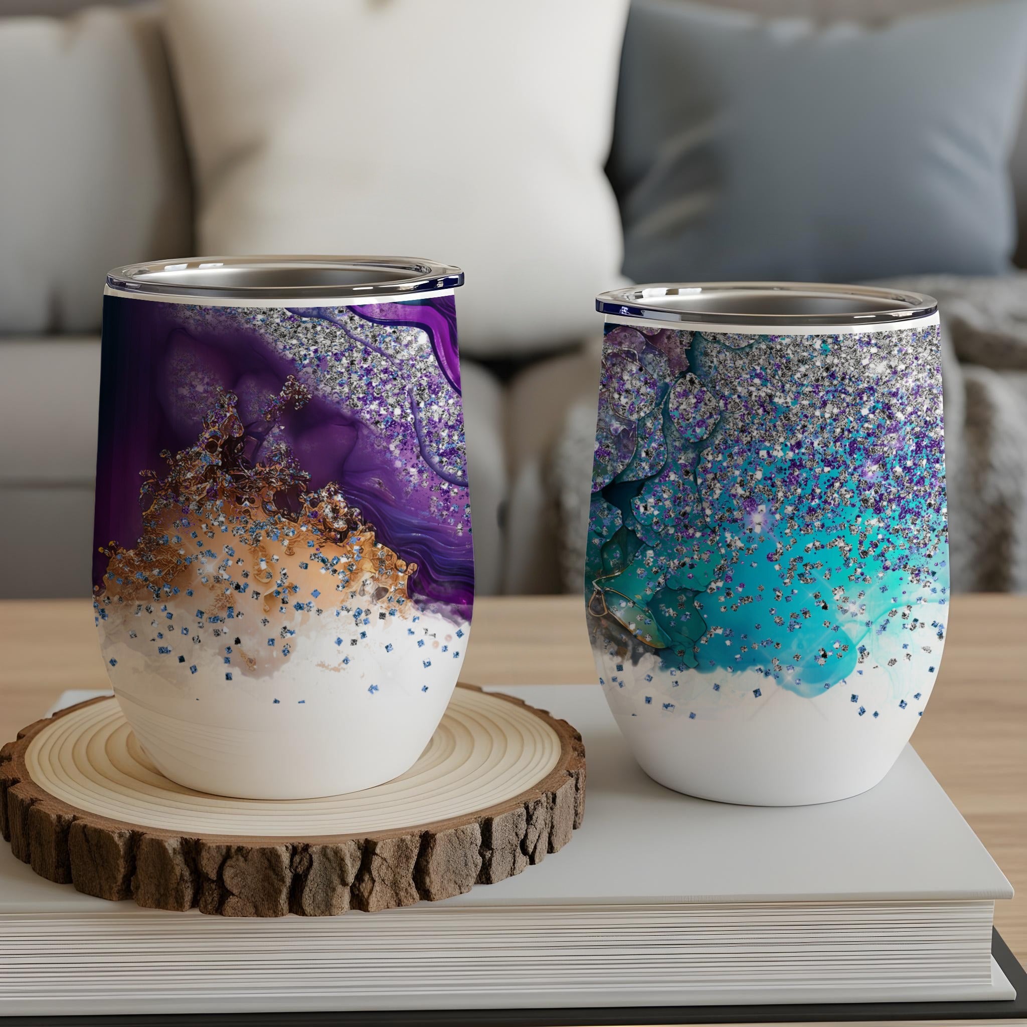 Two patterned tumblers with purple and teal glitter and abstract designs.