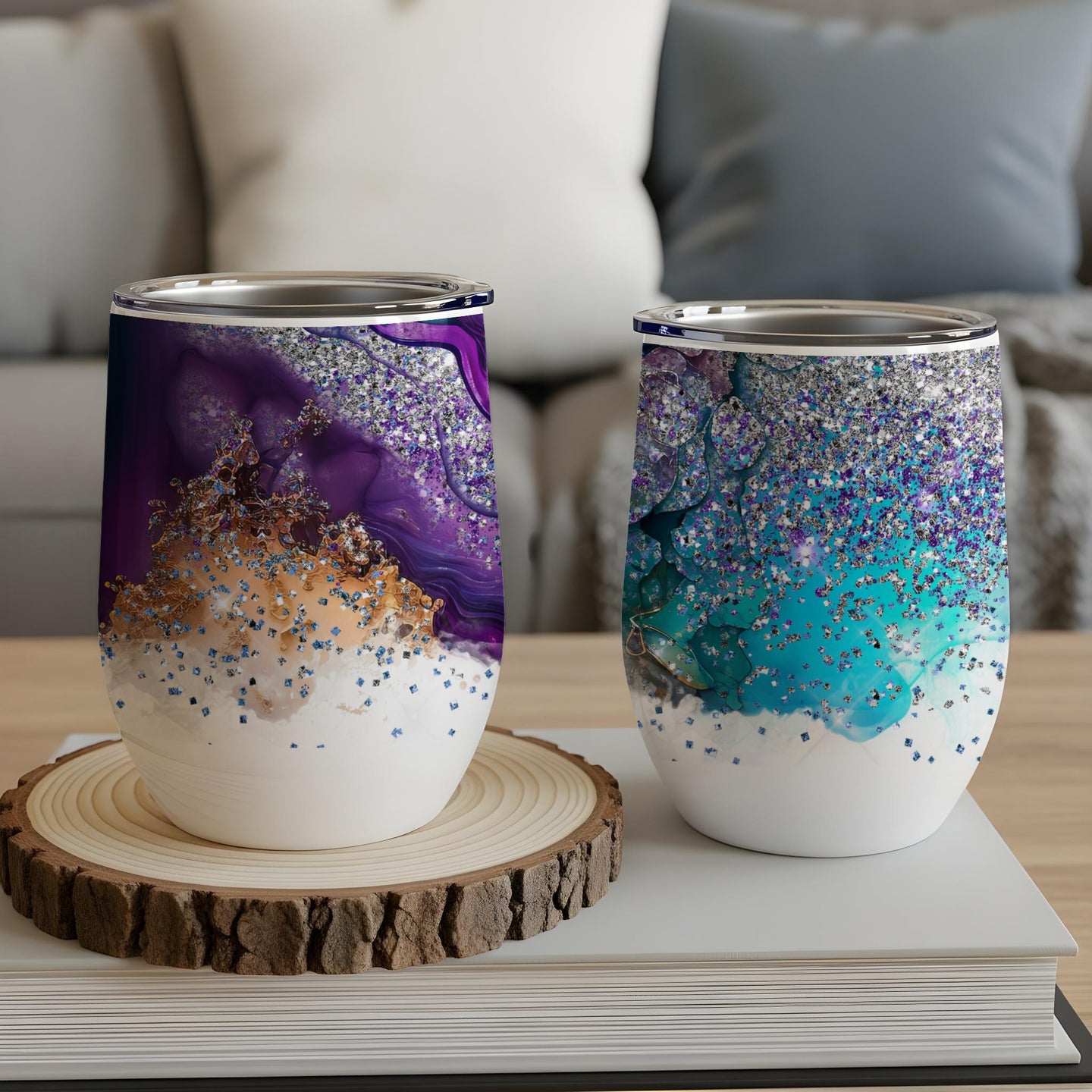 Two patterned tumblers with purple and teal glitter and abstract designs.