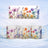 Mug with watercolor floral design against a winter landscape background.