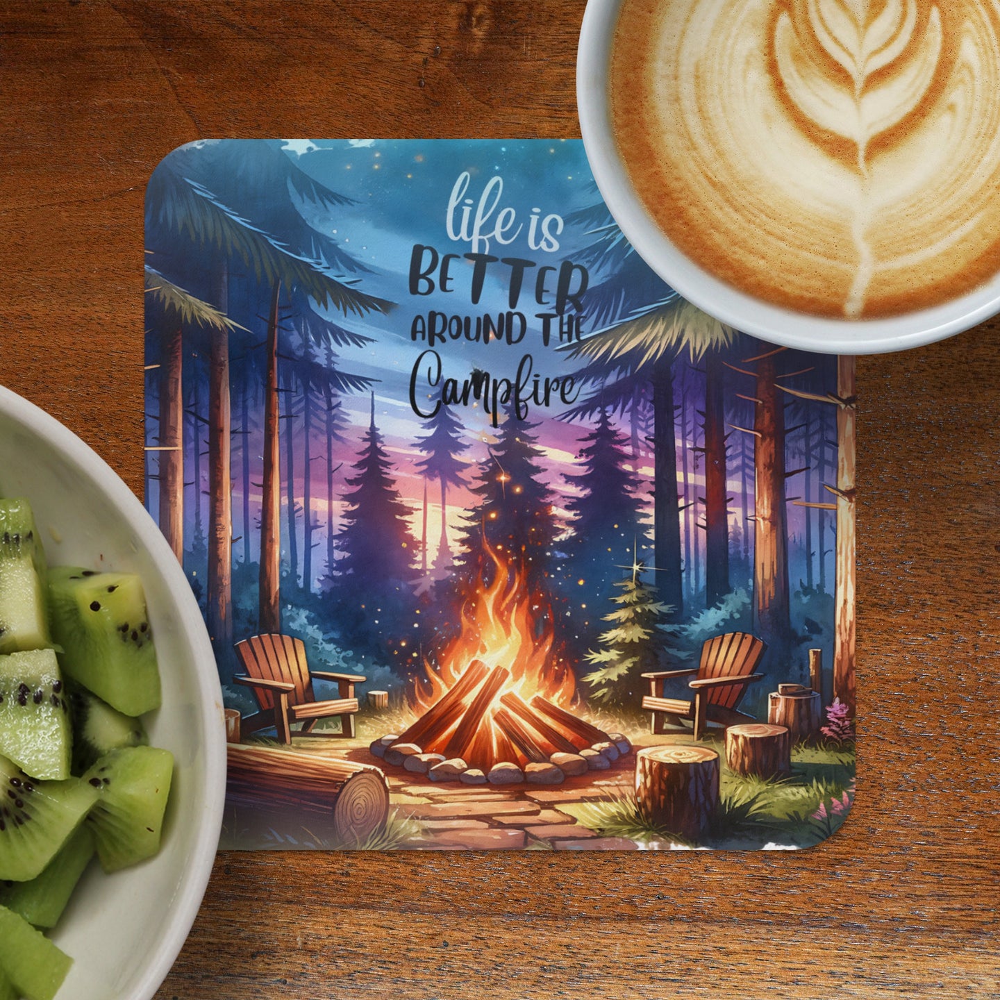 Campfire scene with inspirational text and latte art beside a bowl of kiwi.