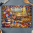 Patriotic kitchen scene with American flag jar of flowers, pie, and cookies.