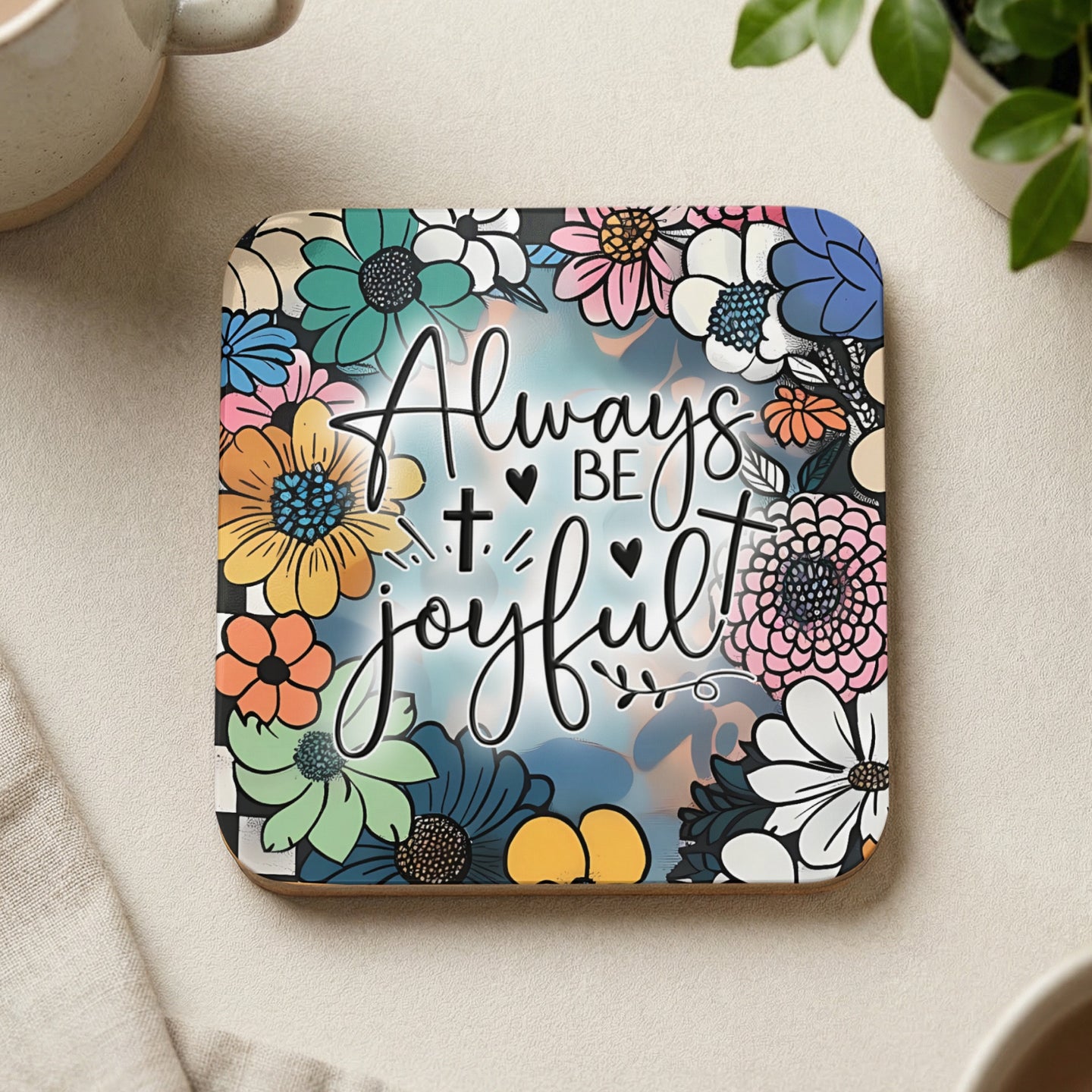Coaster with "Always be joyful" text surrounded by colorful flowers.