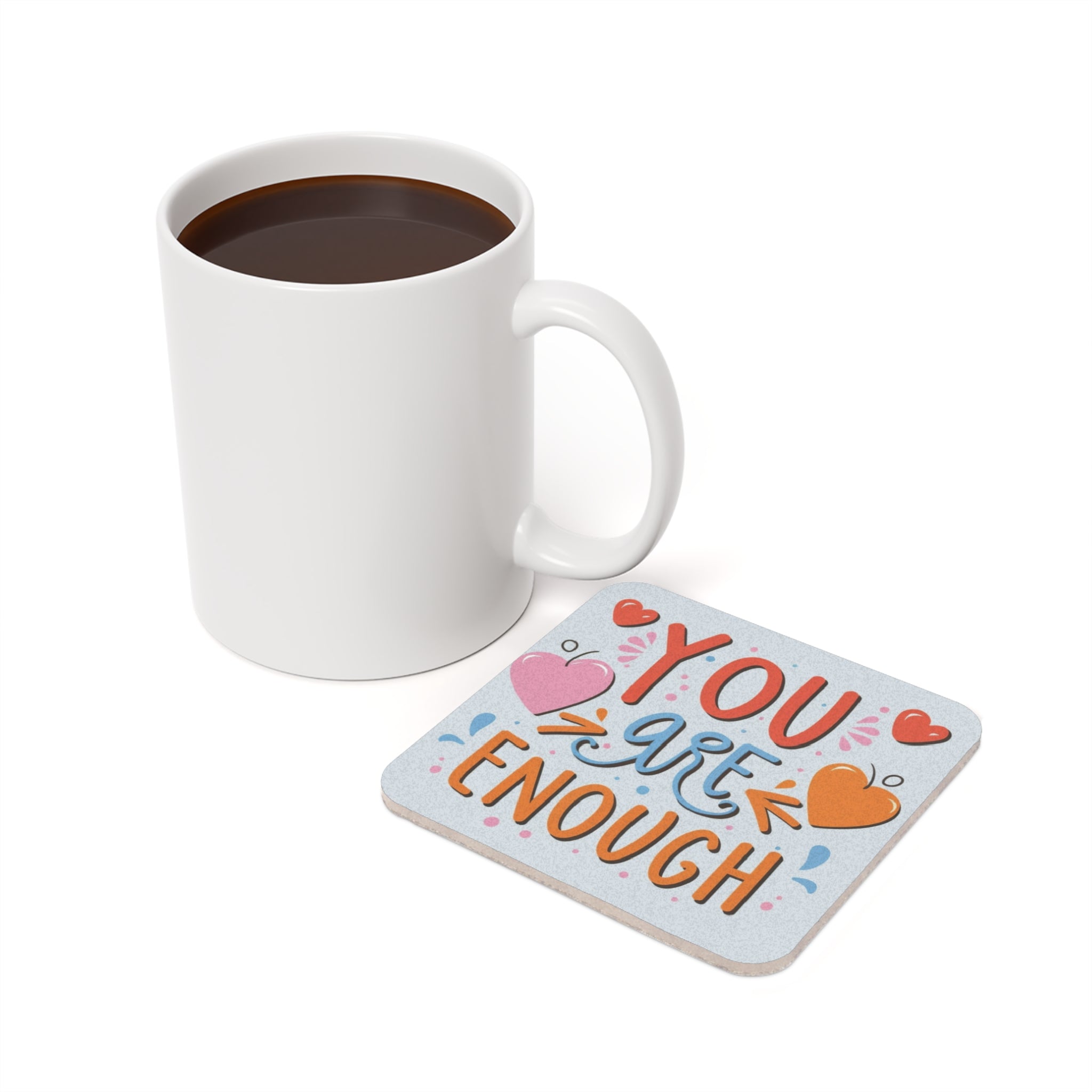 White mug and coaster with text "You Are Enough" and heart designs.