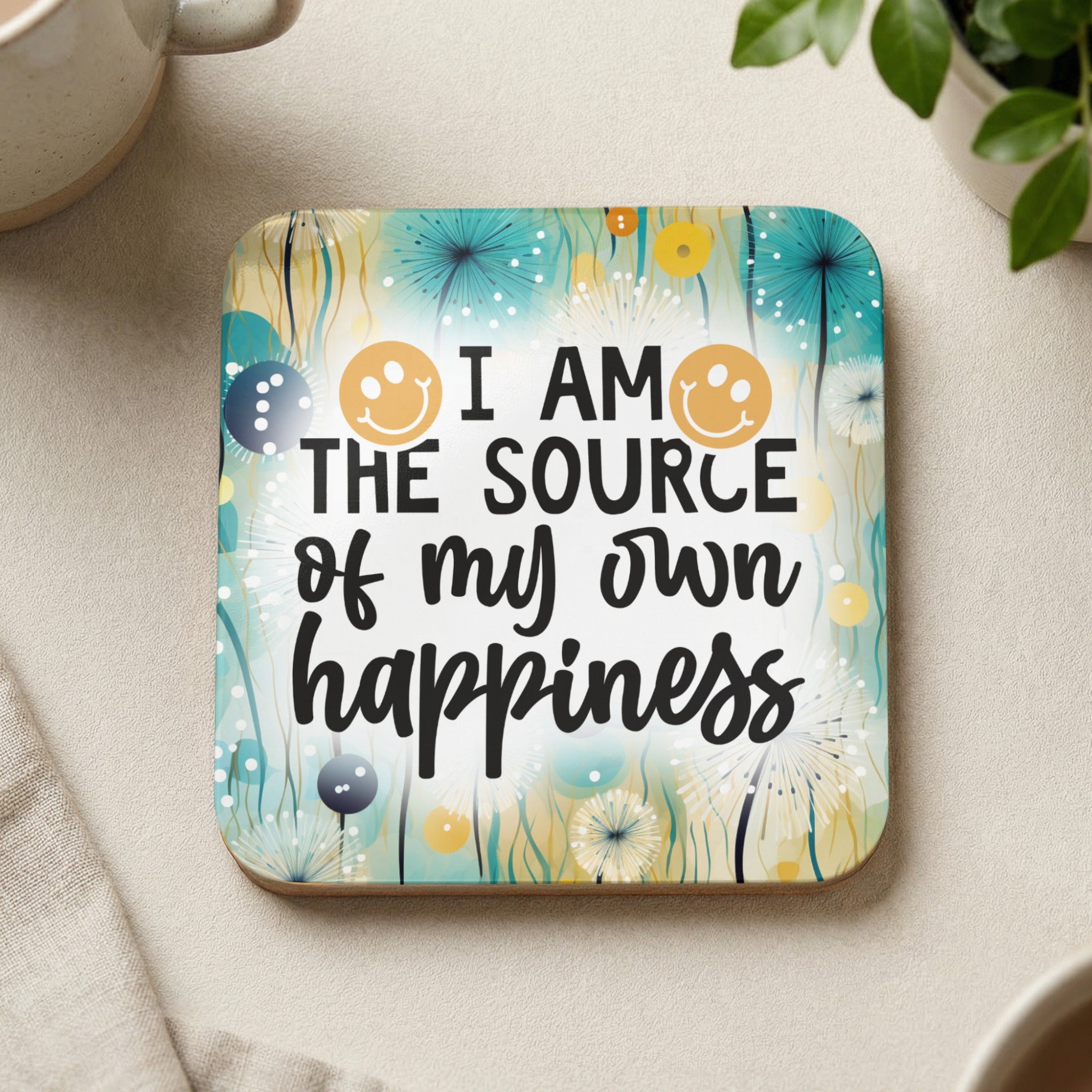 Coaster with text "I AM THE SOURCE of my own happiness" and smiling emojis.