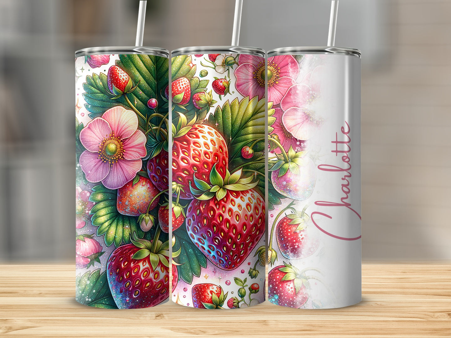 Three tumblers with strawberry and floral designs, one with "Charlotte" text.