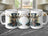 Three mugs featuring a steampunk deer wearing a hat and bowtie.