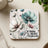 Coaster with delicate floral illustration and "Strong Brave Fearless" text.