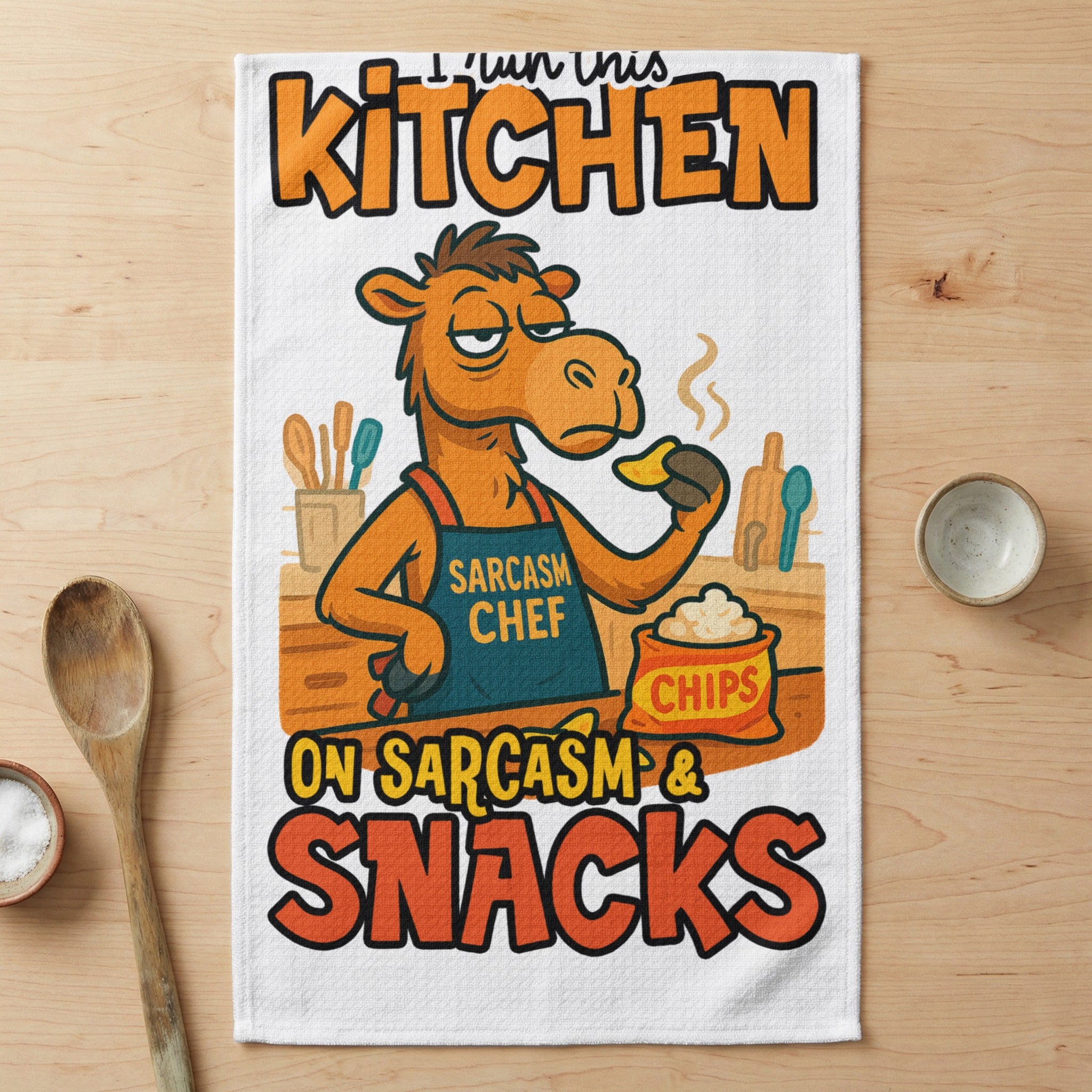 Camel wearing apron that says "Sarcasm Chef" and "I run this kitchen on sarcasm & snacks."