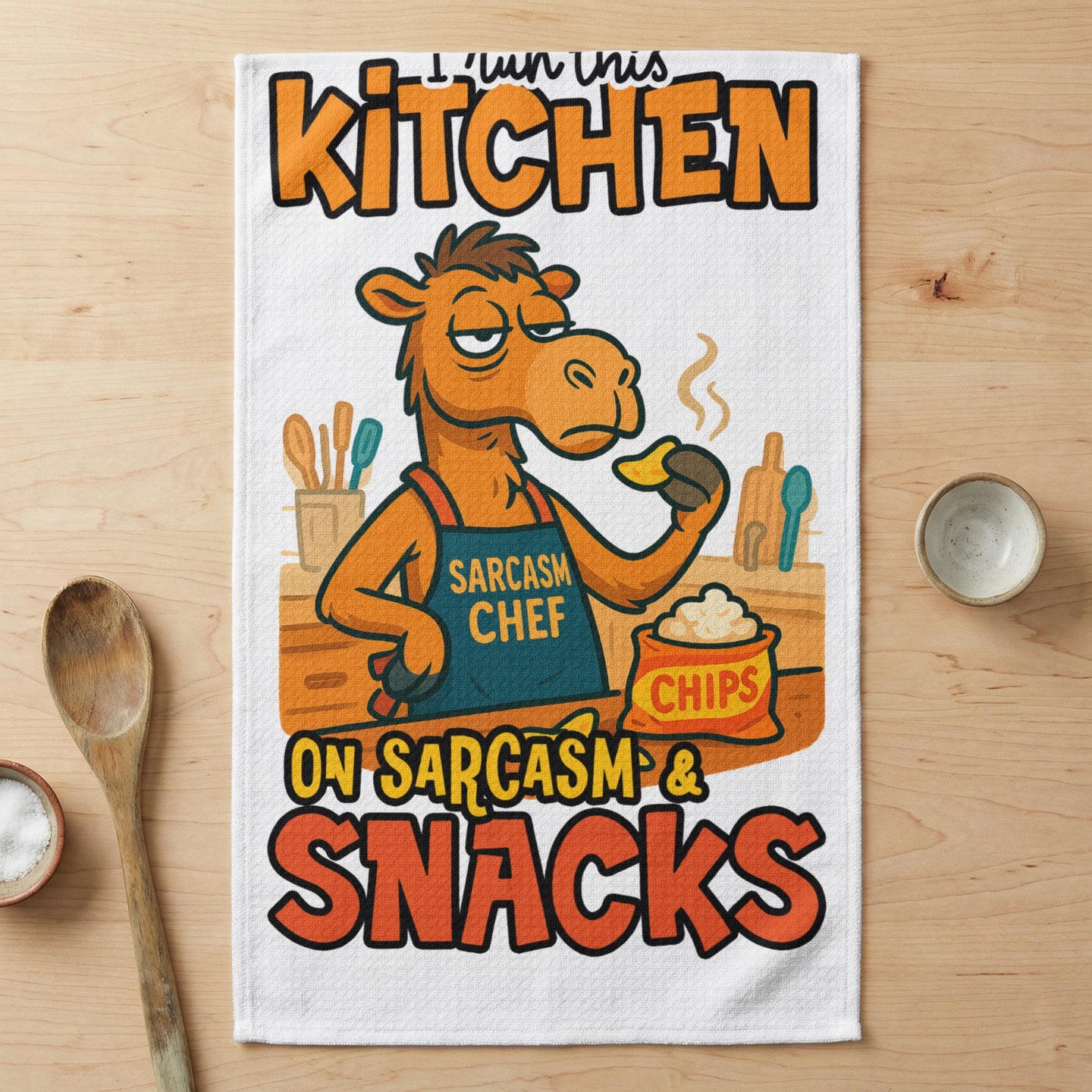 Camel wearing apron that says "Sarcasm Chef" and "I run this kitchen on sarcasm & snacks."