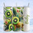 Three tumblers with kiwi fruit and floral designs, one personalized with "Bailey".