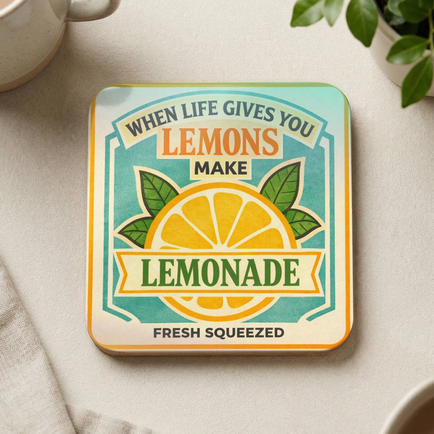 Square coaster with "When life gives you lemons make lemonade" text and lemon illustration.