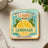 Square coaster with "When life gives you lemons make lemonade" text and lemon illustration.