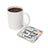 White mug of coffee next to a coaster with "I AM creating the life I WANT" text.