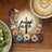 Cross with "faith" text surrounded by flowers, next to kiwi and coffee.