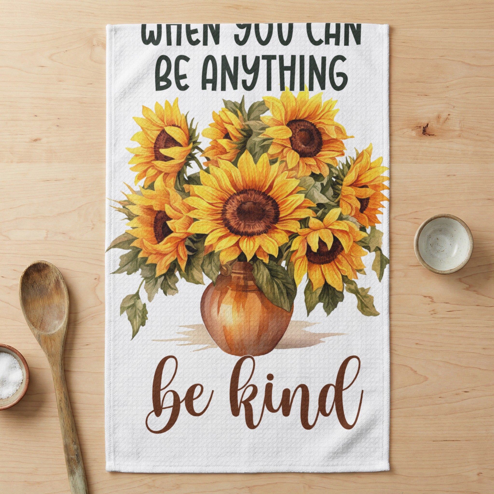 Vase of sunflowers with text "when you can be anything be kind".