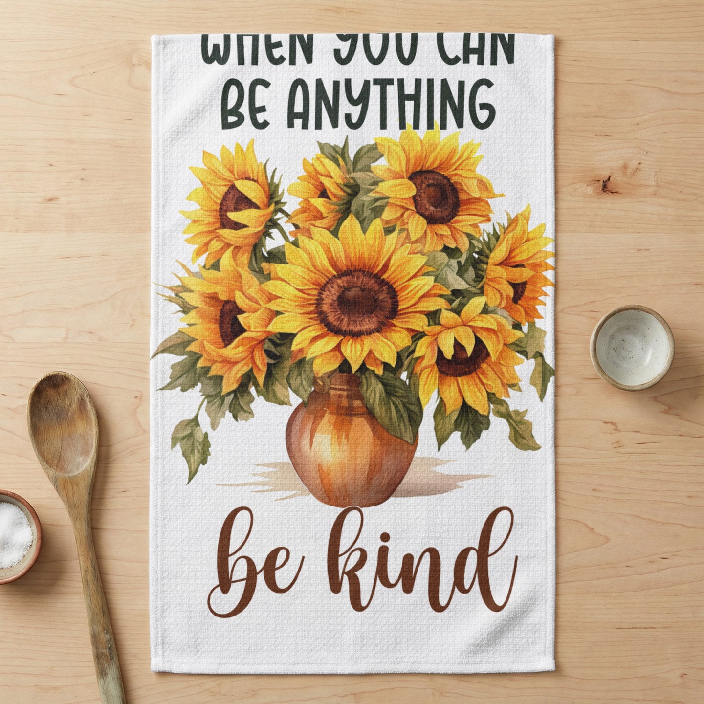 Vase of sunflowers with text "when you can be anything be kind".