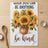 Vase of sunflowers with text "when you can be anything be kind".
