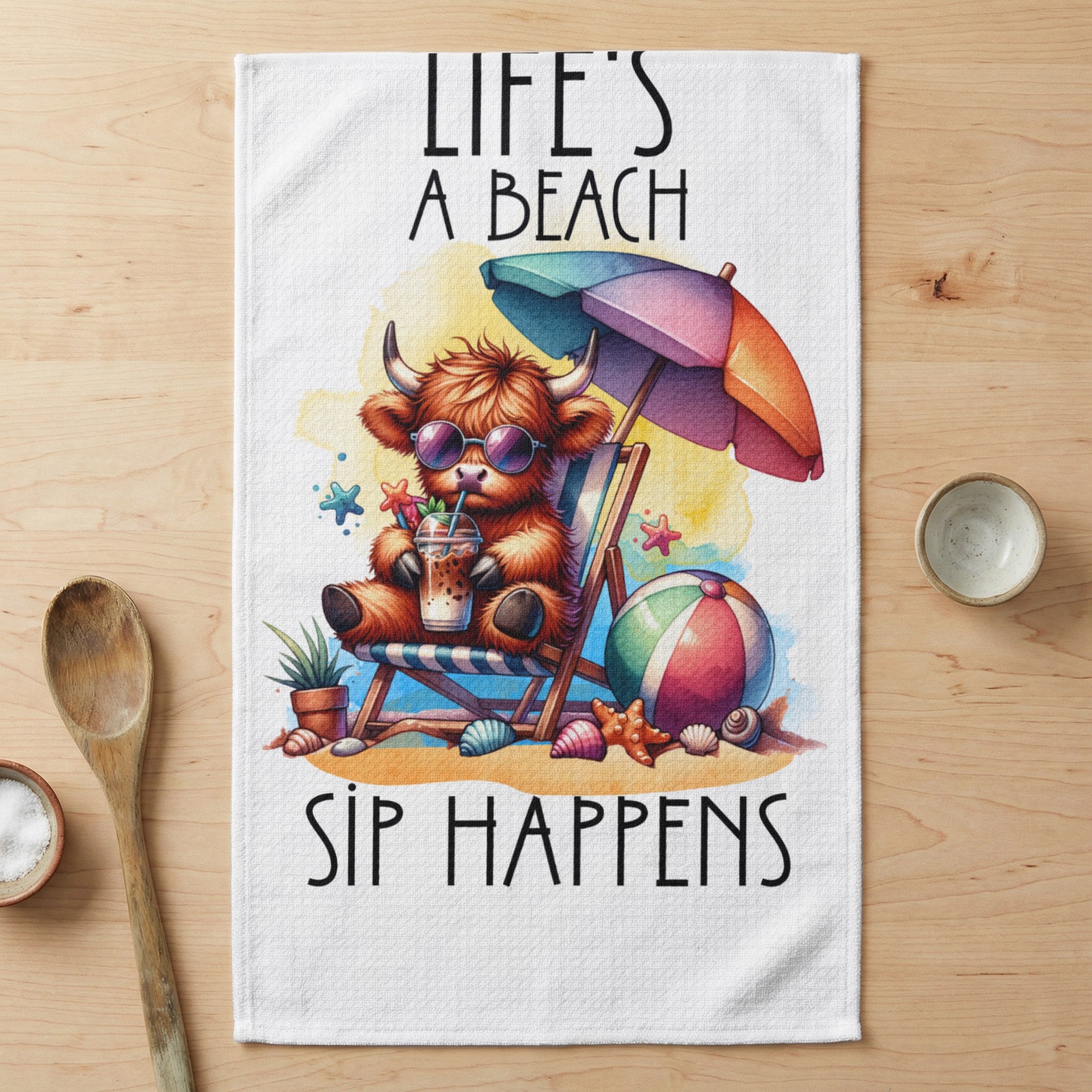 Cow in sunglasses sips drink on beach chair under umbrella, "Life's a Beach, Sip Happens".