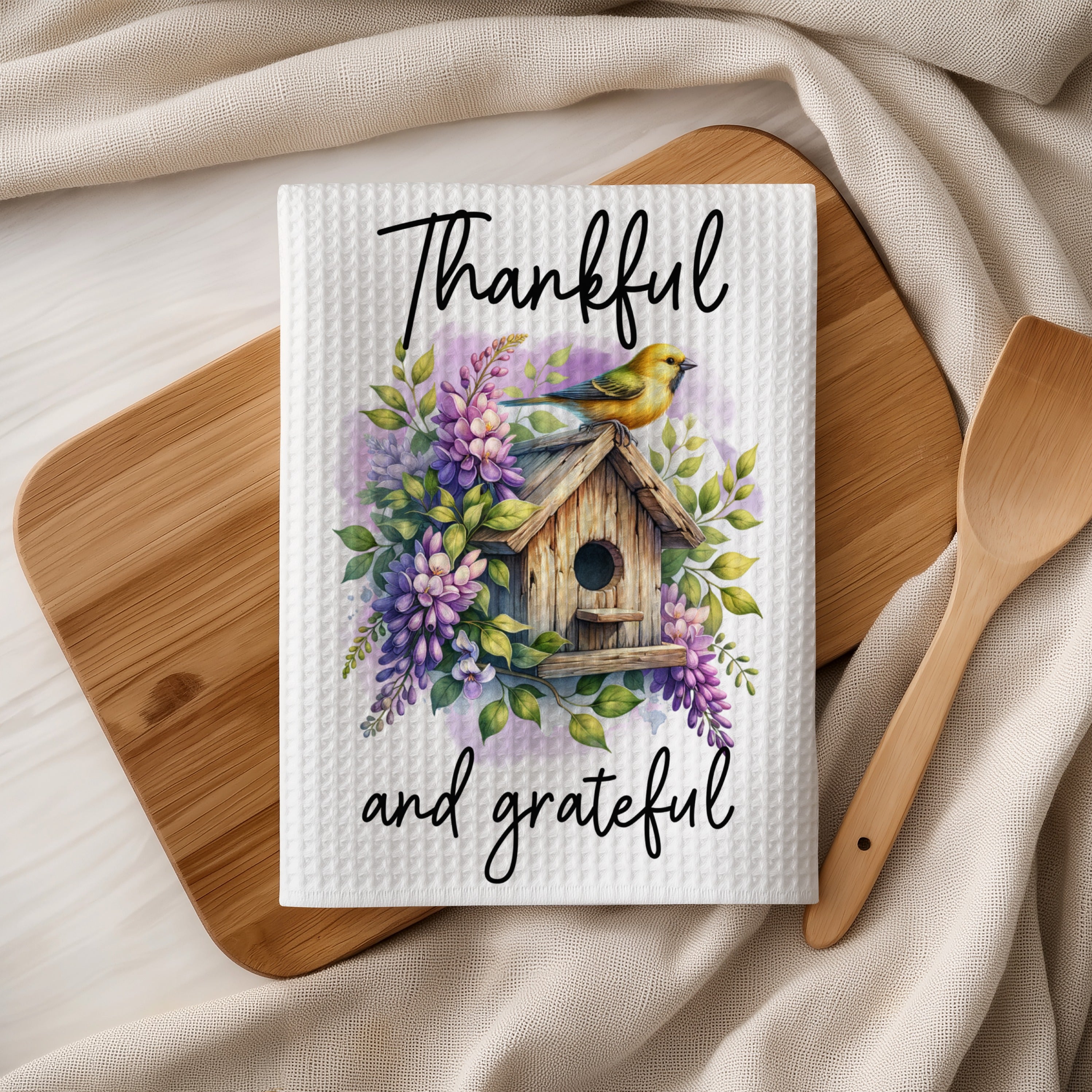 Waffle weave towel with birdhouse, floral design, and "Thankful and grateful" text.