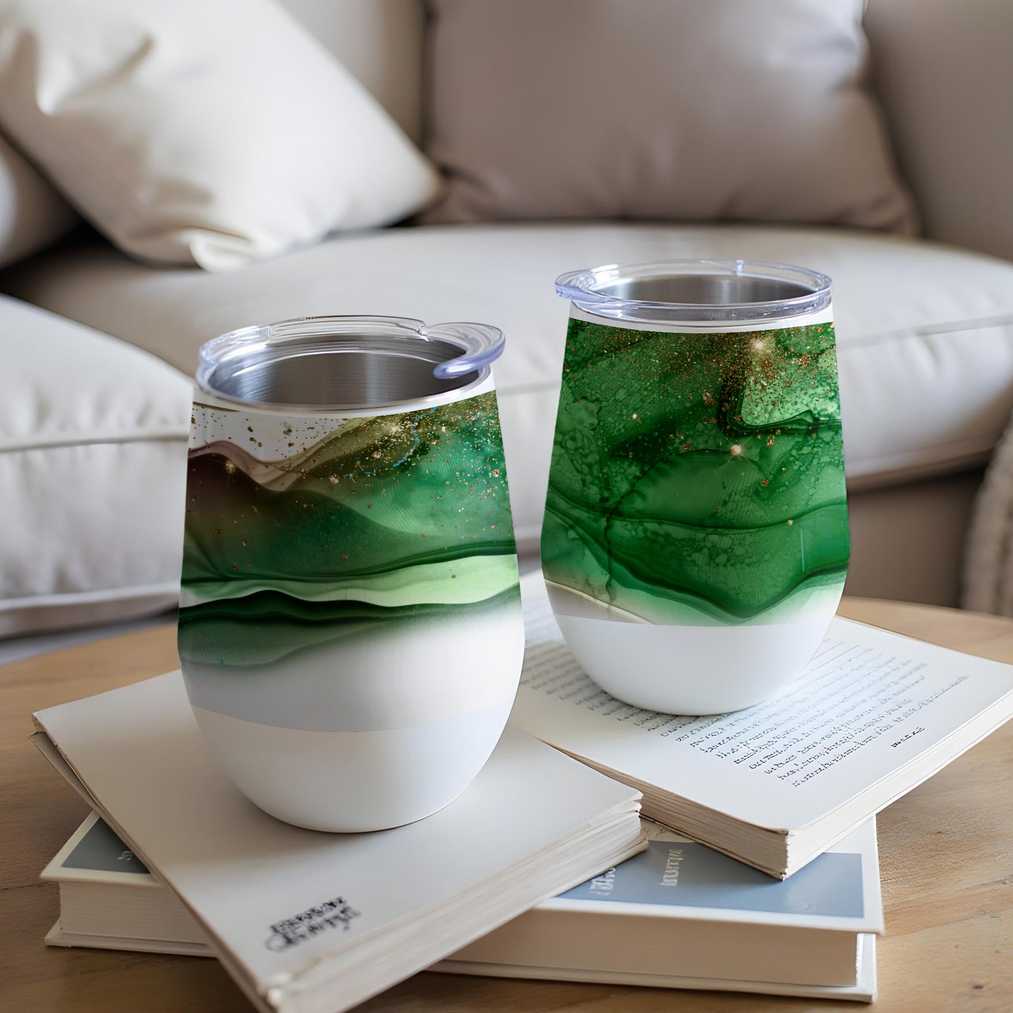 Two white tumblers with green and gold abstract marbled design.