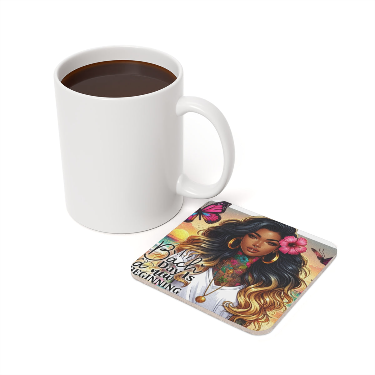 White mug with coffee next to a coaster featuring a woman and butterflies.