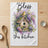 Tea towel with "Bless this kitchen" text and birdhouse floral illustration.