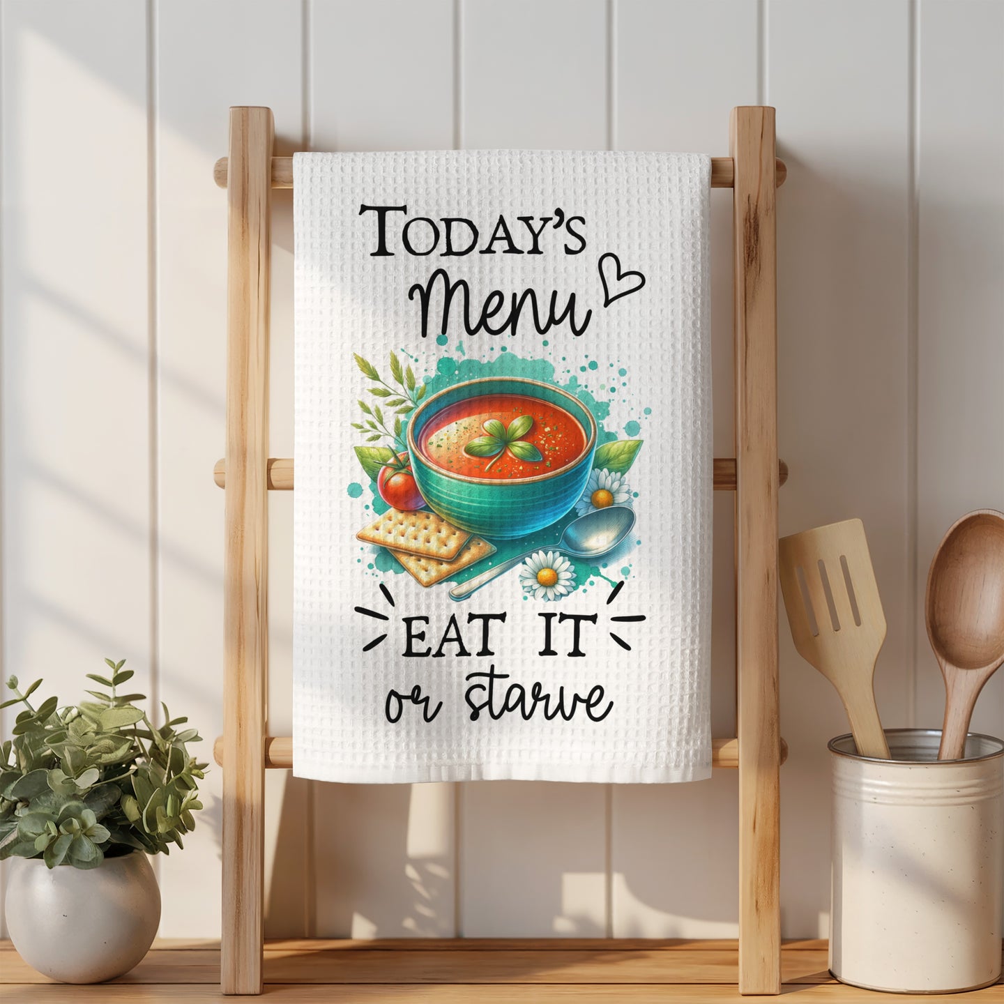 White waffle tea towel with a soup illustration and text: "Today's Menu Eat it or starve".