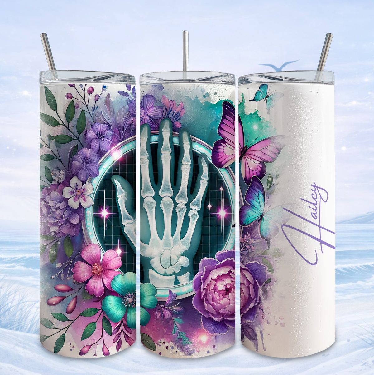 Skeleton hand with floral and butterfly design on a white tumbler.