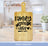 Bamboo cutting board with "Family Gathers Here" text and fork graphic.