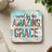 Coaster with "saved by his AMAZING GRACE" text and animal print accents.