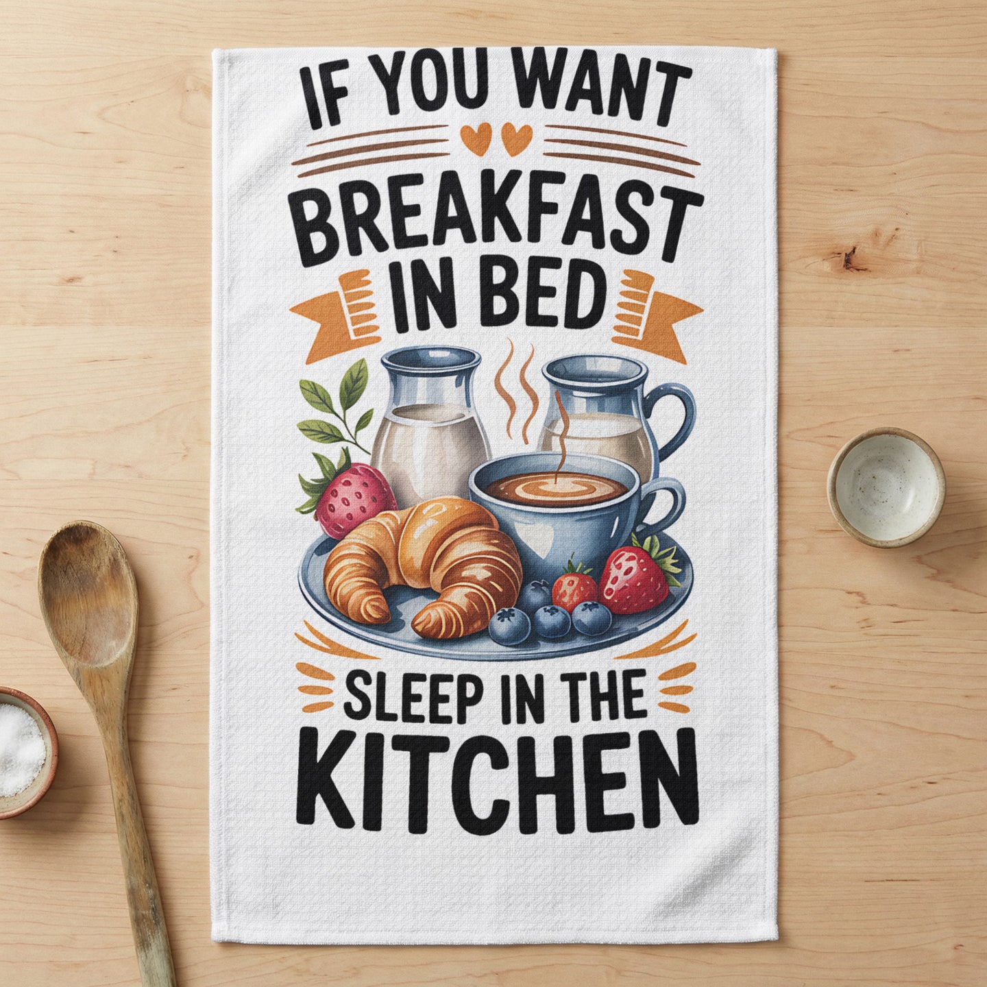 Towel with "If you want breakfast in bed, sleep in the kitchen" text and breakfast items.
