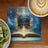 Open book with glowing pages, "Reading Takes You Everywhere" text, coffee and kiwi.