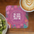 Pink floral coaster with "Be You. Be True. Just Be." text next to coffee and kiwi.