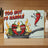 Too Hot to Handle cutting board with cartoon chili peppers in a frying pan.