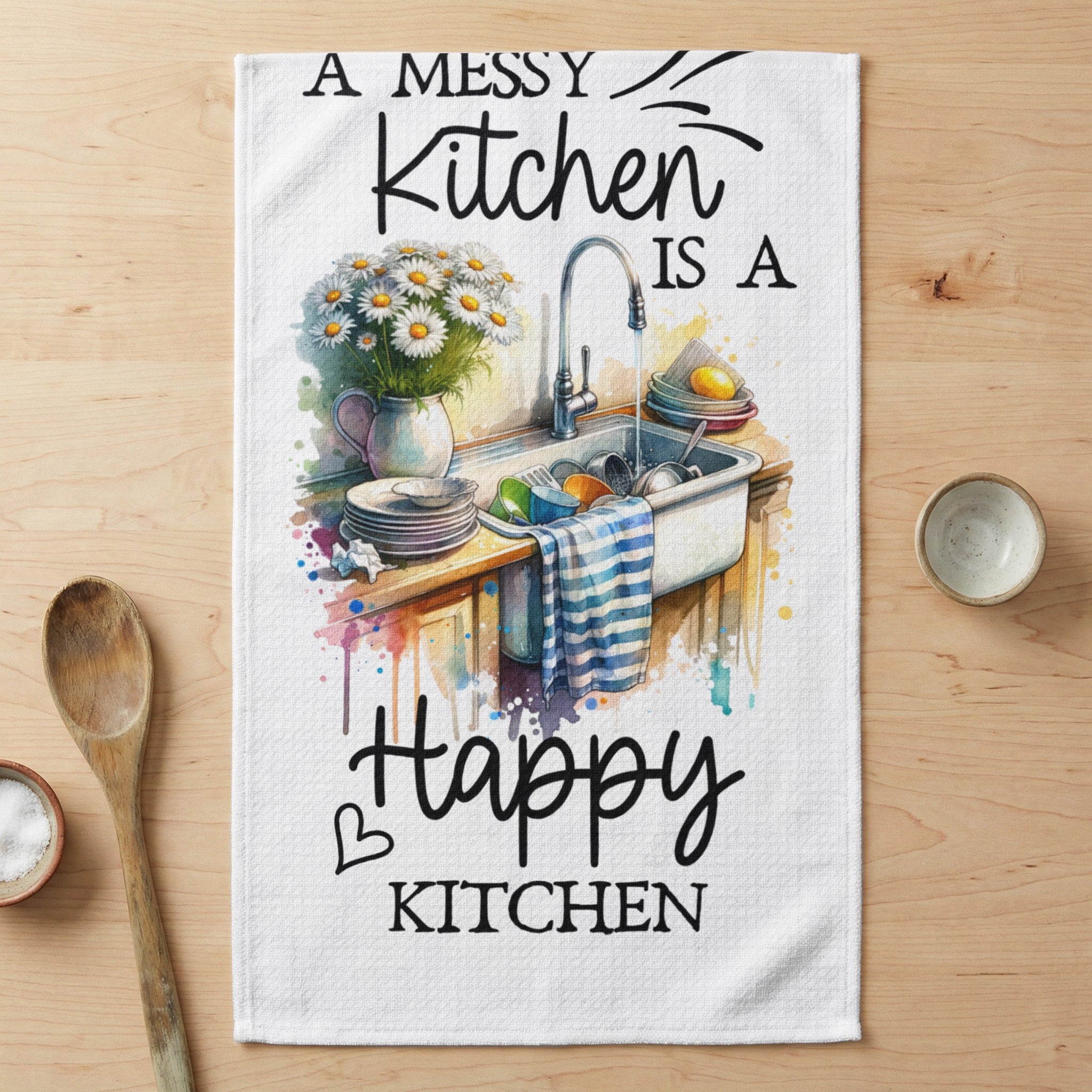 Kitchen towel with watercolor art of dishes in a sink and text "A messy kitchen is a happy kitchen".