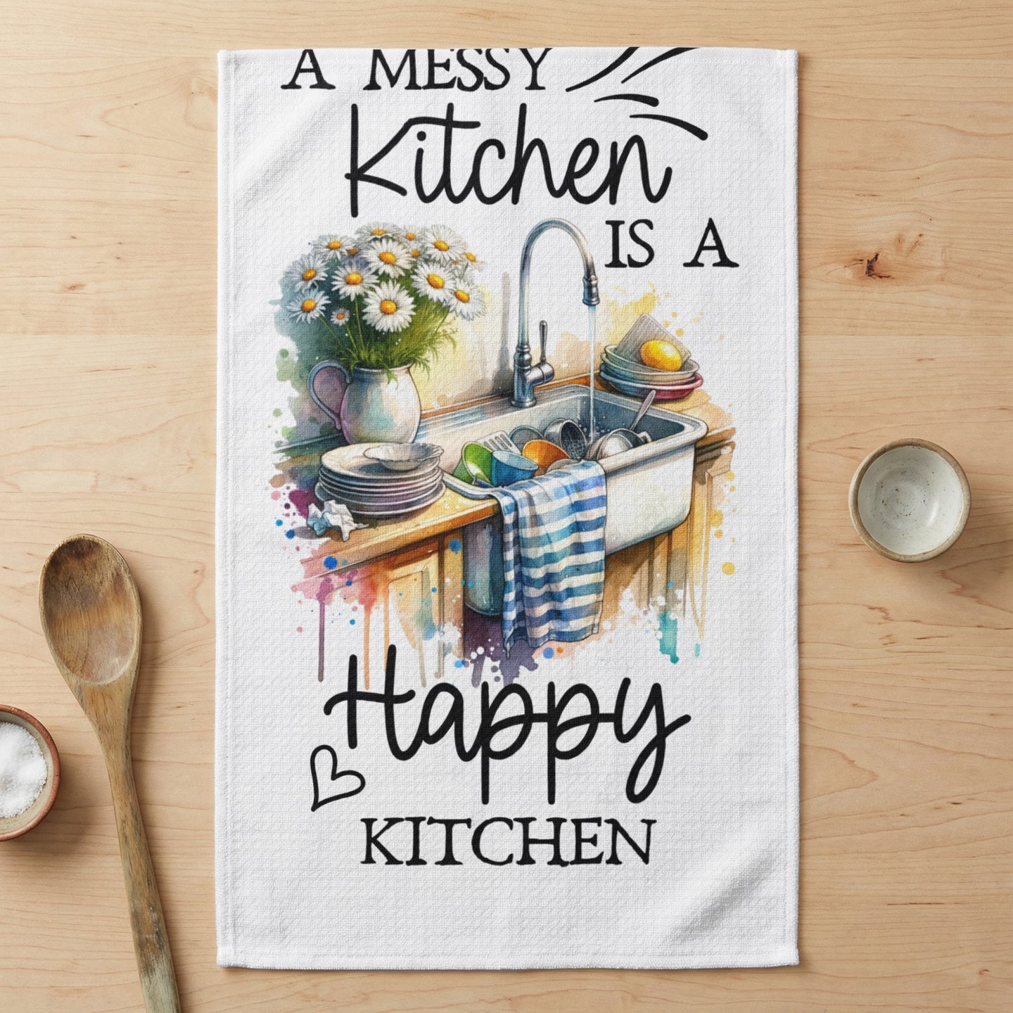 Kitchen towel with watercolor art of dishes in a sink and text "A messy kitchen is a happy kitchen".