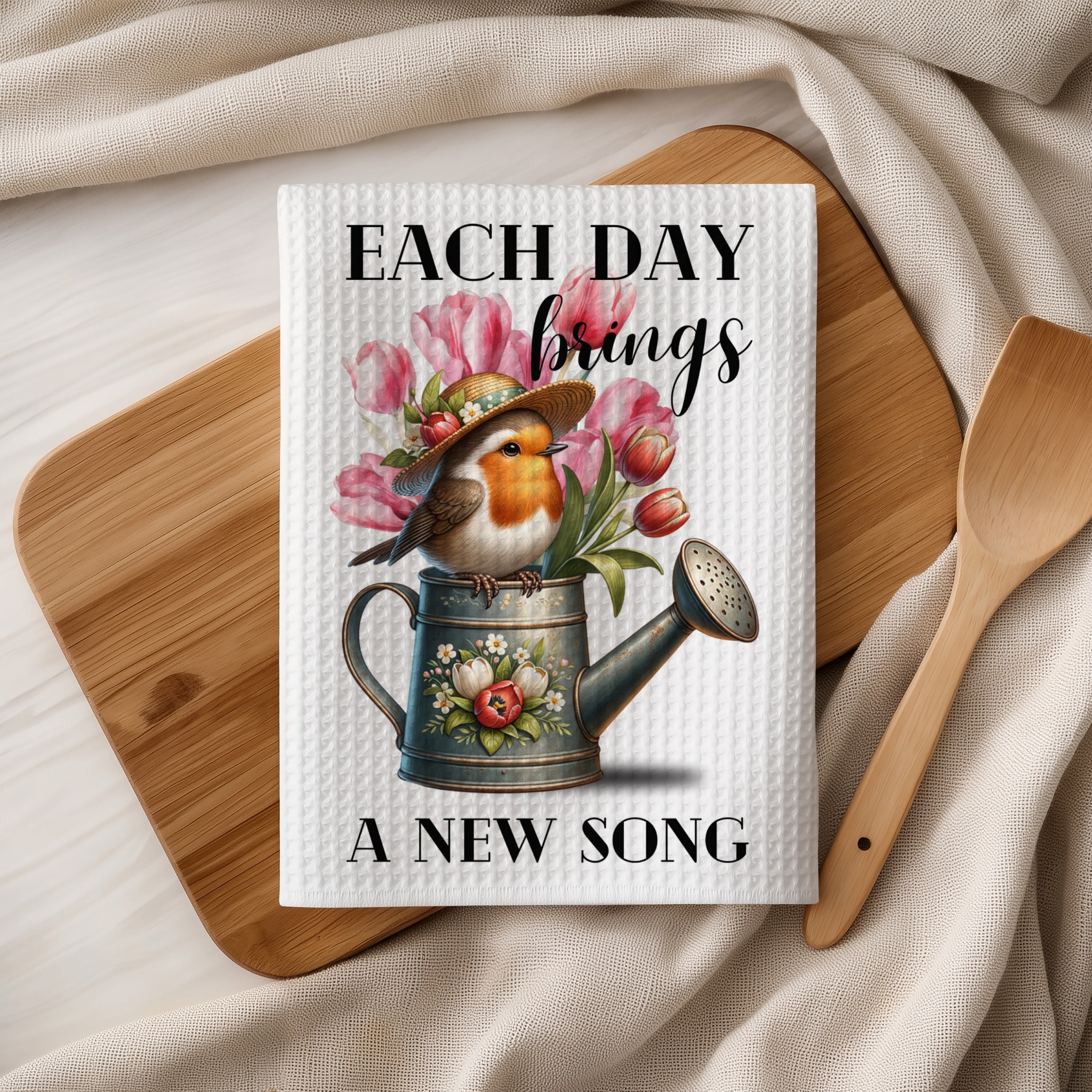 Robin in a watering can with flowers, text "EACH DAY brings A NEW SONG".