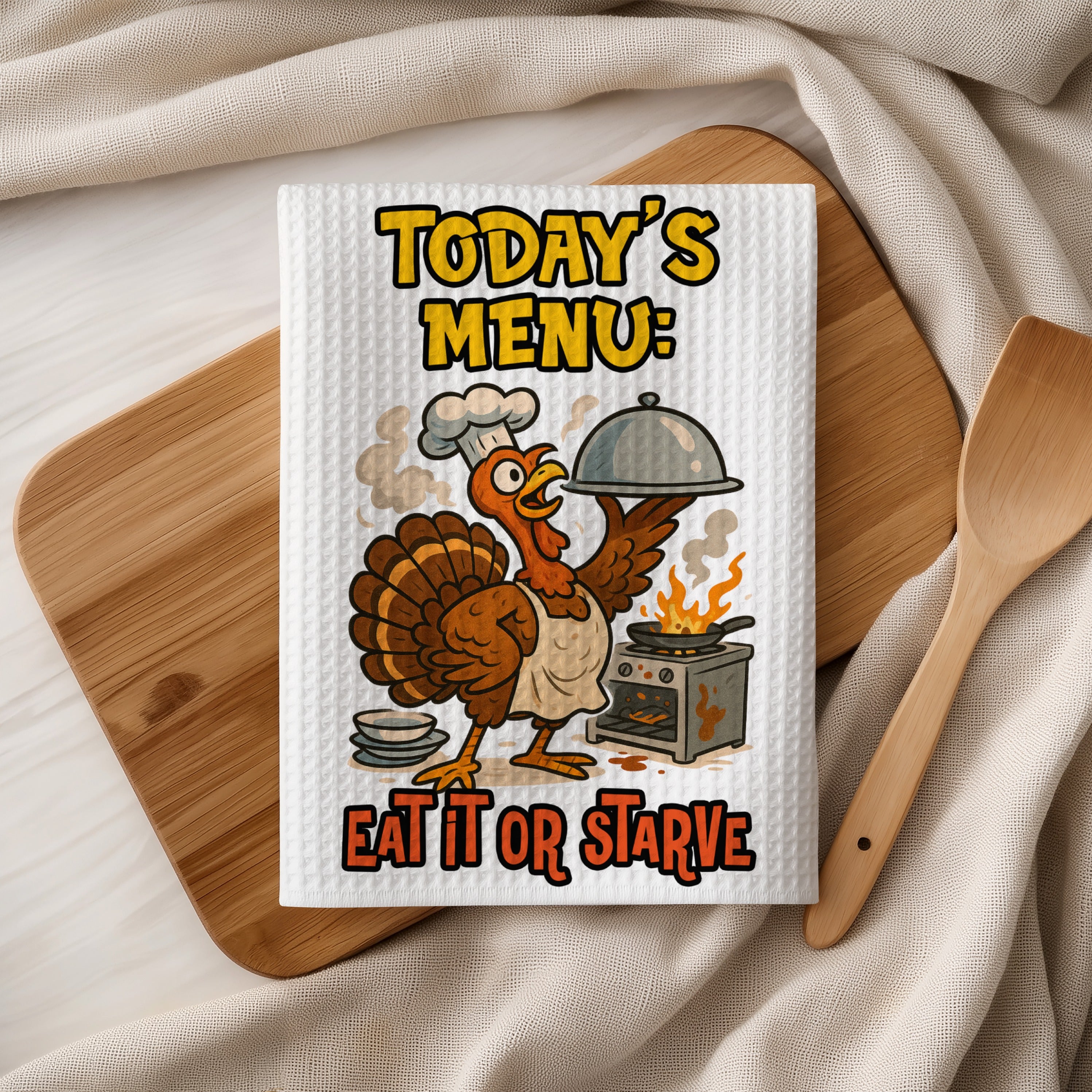 Thanksgiving towel with cartoon turkey chef and text "TODAY'S MENU: EAT IT OR STARVE".