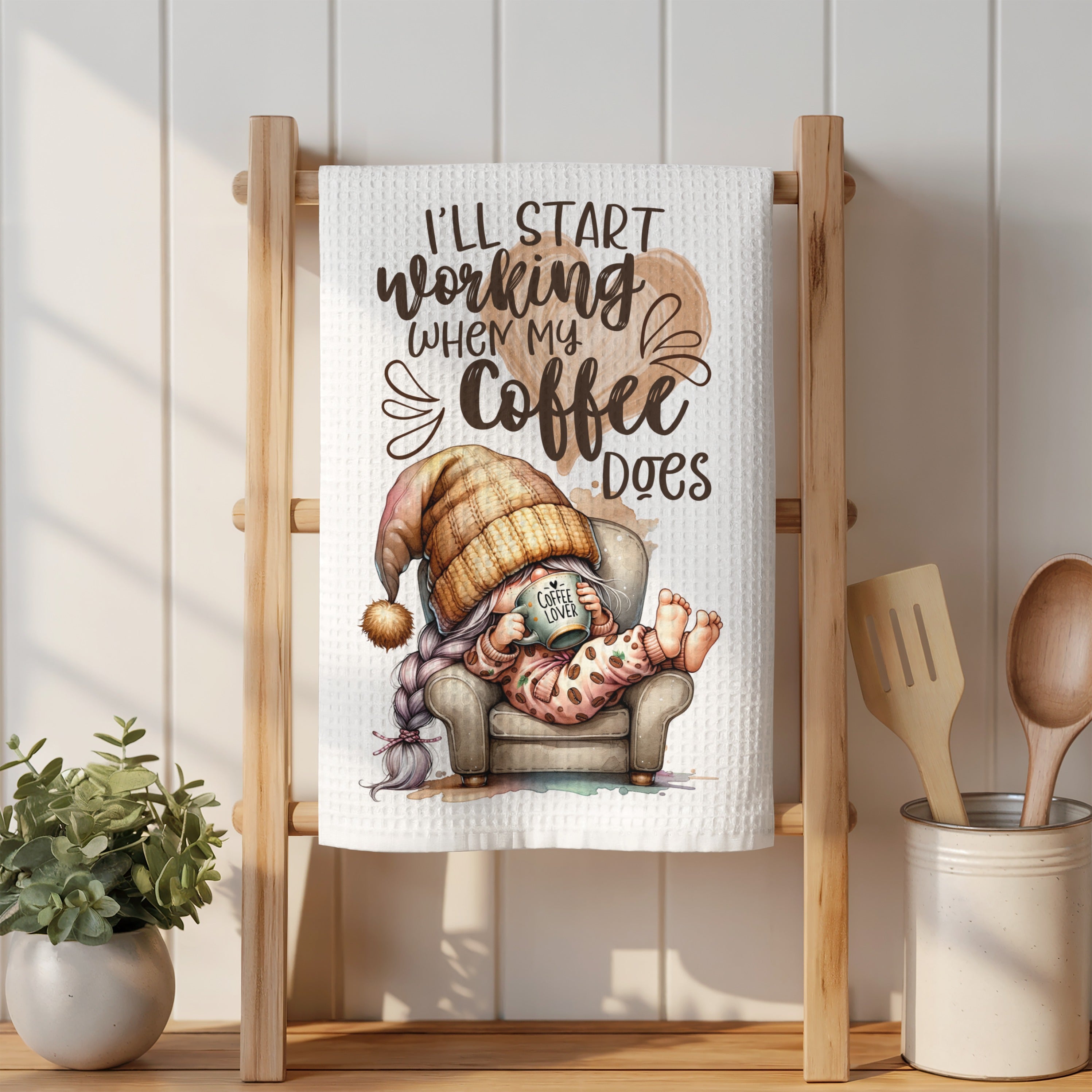 Gnome in pajamas and hat drinking coffee, text "I'll start working when my coffee does".