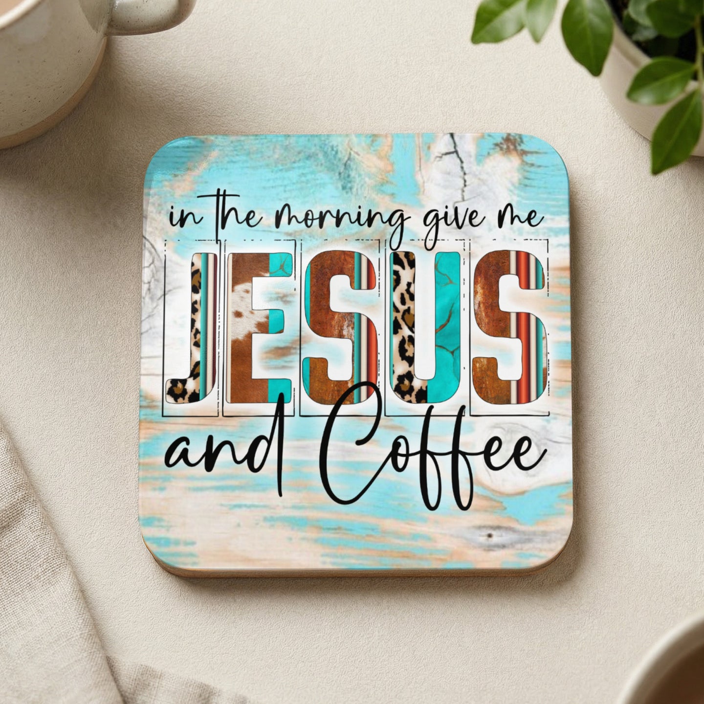 Square coaster with "Jesus and Coffee" text, teal and wood background.