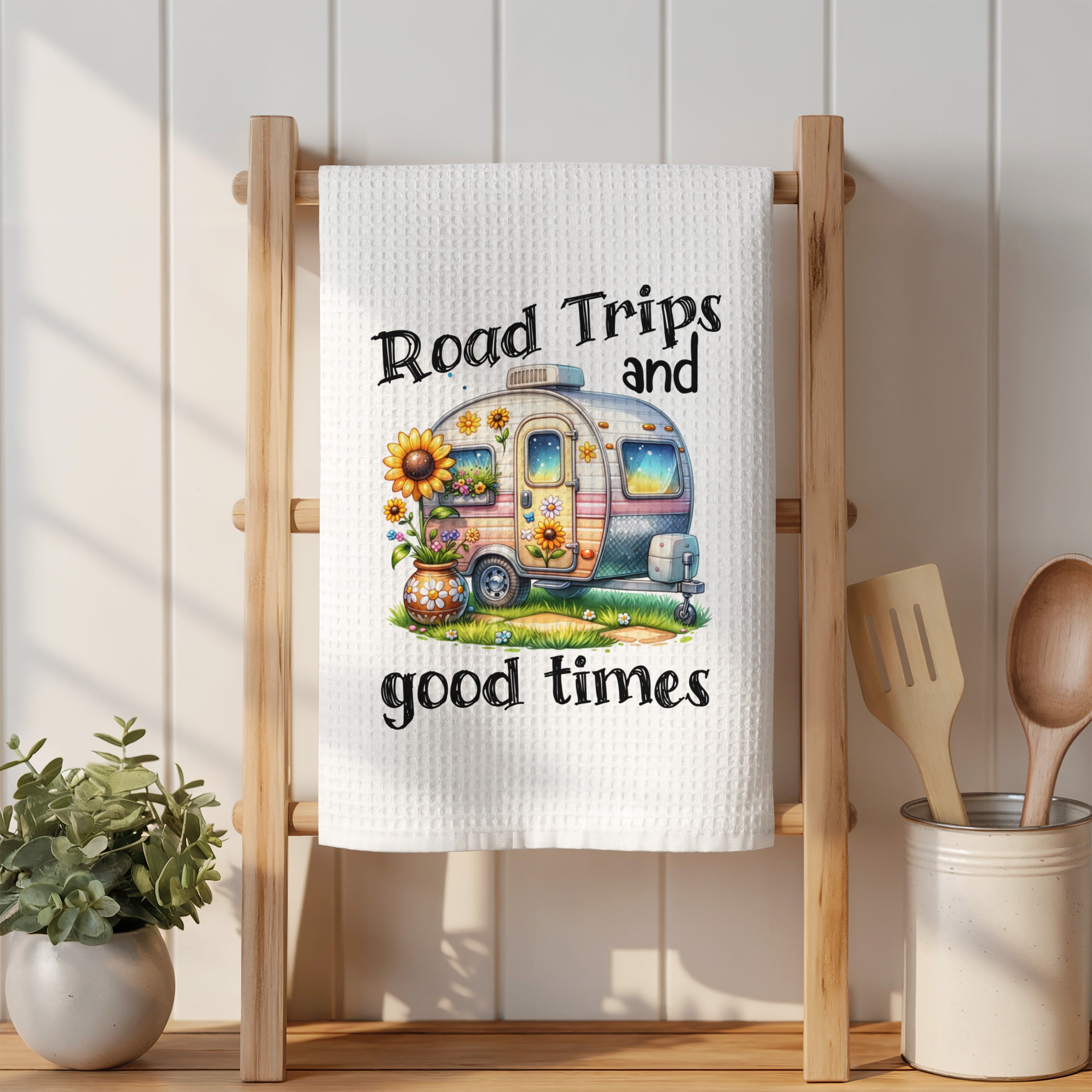 White towel with "Road Trips and good times" text and a colorful camper illustration.