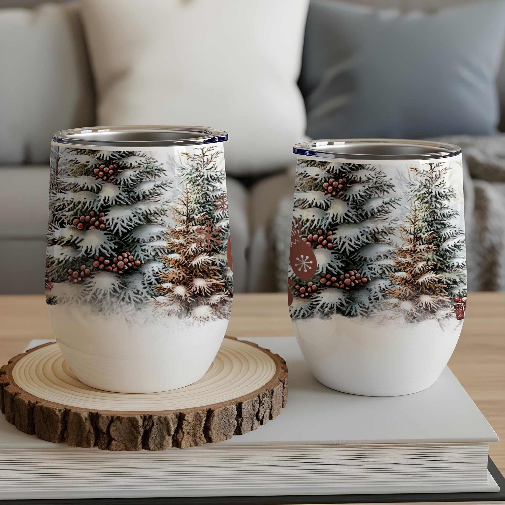 Two insulated wine tumblers with a snowy evergreen tree design.