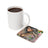 White mug next to square coaster with tattoo art and "BE THE LIGHT" text.