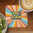 Coaster with "YOU CAN" text in colorful sunburst pattern.