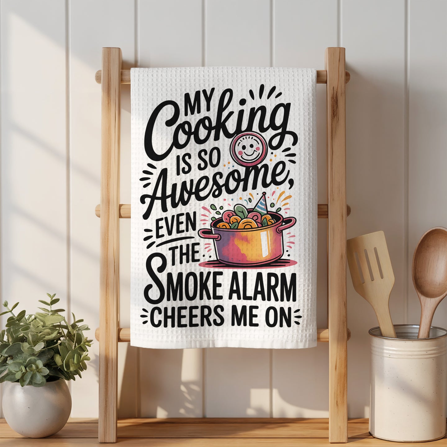 Kitchen towel with "My cooking is so awesome, even the smoke alarm cheers me on" text.
