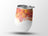 White tumbler with abstract orange and yellow paint splatter design.